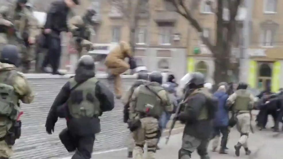 soldiers and civilians running on a wintry street